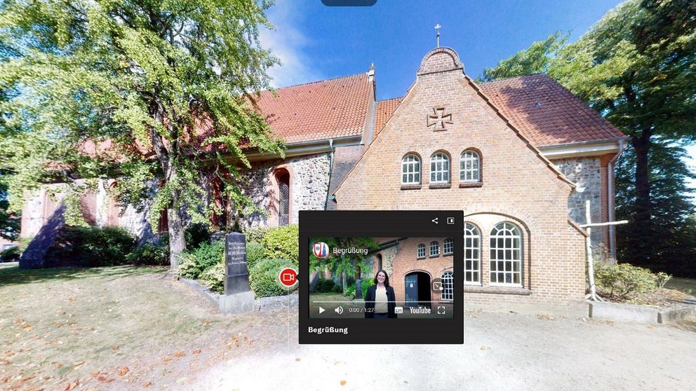 Die Kirche in Schenefeld mit einem digitalen Abbild im Vordergrund 